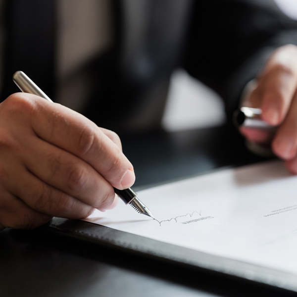Man is writing a signature